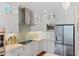 Updated kitchen with sleek stainless steel appliances, mosaic backsplash, and custom white cabinetry at 2630 Tarpon Cove Dr # 212, Punta Gorda, FL 33950