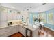 Bright kitchen with white cabinetry, stainless steel appliances, and an adjacent breakfast nook at 2630 Tarpon Cove Dr # 212, Punta Gorda, FL 33950