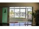 Inviting lanai with expansive windows offering picturesque views of the canal and boats, creating a serene atmosphere at 2630 Tarpon Cove Dr # 212, Punta Gorda, FL 33950