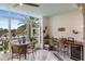 Charming lanai featuring wicker furniture, a built-in bar area, and stunning waterfront views, ideal for entertaining at 2630 Tarpon Cove Dr # 212, Punta Gorda, FL 33950