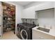 Modern laundry room featuring a pantry, front loading washer and dryer, and a wash sink at 2630 Tarpon Cove Dr # 212, Punta Gorda, FL 33950