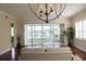 Bright living room features hardwood floors, ceiling fan, and sliding glass doors to lanai at 2630 Tarpon Cove Dr # 212, Punta Gorda, FL 33950