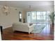 Spacious living room showcasing hardwood floors, ceiling fan, and sliding glass doors to lanai at 2630 Tarpon Cove Dr # 212, Punta Gorda, FL 33950