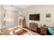 Cozy home office setup with hardwood floors, a large TV, and ample storage space for an efficient workspace at 2630 Tarpon Cove Dr # 212, Punta Gorda, FL 33950