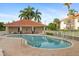 Community pool area with lounge chairs, tables, and well-manicured landscaping, perfect for relaxation and recreation at 2630 Tarpon Cove Dr # 212, Punta Gorda, FL 33950