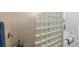 Close up on glass block shower with beige tile surround at 2630 Tarpon Cove Dr # 212, Punta Gorda, FL 33950