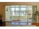 Bright sunroom featuring tiled flooring, waterfront views, and sliding glass doors to the outdoors at 2630 Tarpon Cove Dr # 212, Punta Gorda, FL 33950