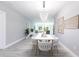 Open-concept dining area with stylish lighting, modern decor, and seating for six at 278 Akers St, Port Charlotte, FL 33953