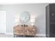 Stylish living room features an elegant wooden cabinet and a round mirror at 278 Akers St, Port Charlotte, FL 33953