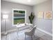 Well-lit home office with a sleek white desk, artwork, and large window with backyard view at 278 Akers St, Port Charlotte, FL 33953