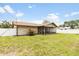 Charming home exterior showcasing a well-maintained backyard and screened-in patio at 3242 Nocturne Rd, Venice, FL 34293