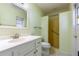 Bathroom featuring a single sink vanity and shower and tub combo with glass shelves at 3242 Nocturne Rd, Venice, FL 34293