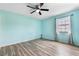 Bedroom features durable laminate floors, ceiling fan and light filled window with curtains at 3242 Nocturne Rd, Venice, FL 34293