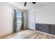 Bedroom features durable laminate floors, wainscotting, window with curtains and an enclosed closet at 3242 Nocturne Rd, Venice, FL 34293