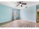 Bedroom featuring durable laminate floors, ceiling fan and light filled window with curtains at 3242 Nocturne Rd, Venice, FL 34293