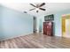 Bedroom featuring durable laminate floors, ceiling fan and light filled window with closet entrance at 3242 Nocturne Rd, Venice, FL 34293