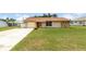 Charming single-story home with stone accents, a well-manicured lawn, and attached garage at 3242 Nocturne Rd, Venice, FL 34293