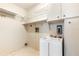 Functional laundry room with built-in shelving, cabinets, and a utility sink at 3242 Nocturne Rd, Venice, FL 34293