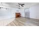Spacious living room features laminate flooring, a ceiling fan, and access to the entrance and dining area at 3242 Nocturne Rd, Venice, FL 34293