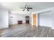 Spacious living room featuring modern laminate floors, a ceiling fan, and neutral wall paint at 3242 Nocturne Rd, Venice, FL 34293