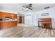 Open-concept space with laminate flooring, access to the kitchen, and a cozy traditional-style piano at 3242 Nocturne Rd, Venice, FL 34293