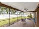 Enclosed patio features brick floors with a fan and a lovely view of the home's backyard at 3242 Nocturne Rd, Venice, FL 34293