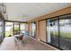 Cozy screened patio with brick flooring and sliding glass doors offers seamless indoor-outdoor living at 3242 Nocturne Rd, Venice, FL 34293