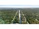 High angle of canal-front homes surrounded by lush green trees in a tranquil neighborhood setting at 372 Cory St, Port Charlotte, FL 33953