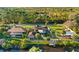 Aerial view of a waterfront property with a screened-in pool, a backyard with a fire pit, and a private dock at 372 Cory St, Port Charlotte, FL 33953