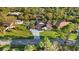 Aerial view of single-story home with canal access, screened pool, and lush landscaping at 372 Cory St, Port Charlotte, FL 33953