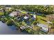 Aerial view of waterfront home with mature landscaping, fire pit, a private dock, and canal access at 372 Cory St, Port Charlotte, FL 33953