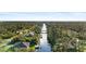 Scenic aerial view of canal-front homes nestled among lush green trees in a peaceful neighborhood at 372 Cory St, Port Charlotte, FL 33953
