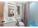Functional bathroom featuring a blue sink and tub with a shower and view into the living area at 372 Cory St, Port Charlotte, FL 33953