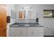 Bright bathroom with updated features including dual sinks, toilet and white wainscoting at 372 Cory St, Port Charlotte, FL 33953