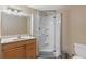 Bathroom features a vanity with a mirror, a shower with glass door, and tiled floors at 372 Cory St, Port Charlotte, FL 33953