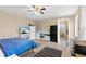 A cozy bedroom features tile floors, a ceiling fan, a compact refrigerator, and ample storage at 372 Cory St, Port Charlotte, FL 33953