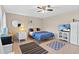 A cozy bedroom with a queen-sized bed, tile flooring, and a ceiling fan at 372 Cory St, Port Charlotte, FL 33953