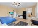 A cozy bedroom features tile floors, a ceiling fan, a compact refrigerator, and ample storage at 372 Cory St, Port Charlotte, FL 33953
