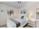Cozy bedroom features a comfortable bed, natural light, and simple decor with a beach-themed art piece at 372 Cory St, Port Charlotte, FL 33953