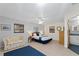 Bright bedroom with a full bed, two windows and a cozy sitting area with doorway to bathroom at 372 Cory St, Port Charlotte, FL 33953