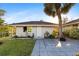 A charming home with a well-manicured lawn and a large palm tree at 372 Cory St, Port Charlotte, FL 33953