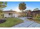 A charming home with a well-manicured lawn and a large palm tree at 372 Cory St, Port Charlotte, FL 33953
