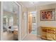 Hallway with tile flooring shows views into the bedroom and bathroom with an art display at 372 Cory St, Port Charlotte, FL 33953