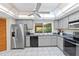 Functional kitchen with stainless steel appliances, ample counter space, and a well-lit skylight at 372 Cory St, Port Charlotte, FL 33953