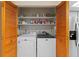 Bright laundry area featuring a new, matching washer and dryer set with white shelving for supplies at 372 Cory St, Port Charlotte, FL 33953