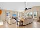 Bright living room boasts comfortable seating, natural light from large windows, and neutral tones at 372 Cory St, Port Charlotte, FL 33953