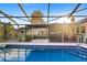 An in-ground pool with a screened enclosure and comfortable outdoor seating at 372 Cory St, Port Charlotte, FL 33953