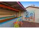 An outdoor tiki bar with colorful seating, a wooden countertop, and cheerful island artwork at 372 Cory St, Port Charlotte, FL 33953