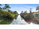 Scenic canal view lined with lush trees and blue sky at 372 Cory St, Port Charlotte, FL 33953