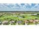 Expansive aerial shot featuring a verdant golf course, peaceful lakes, and a community of beautiful homes at 3724 Bordeaux Dr, Punta Gorda, FL 33950
